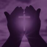 Hands with cross on purple background